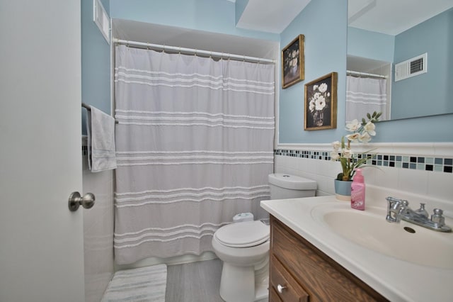4901 Golf Rd Unit 310, Skokie, IL 60077 - full bath featuring toilet, vanity, tile walls, and a shower with shower curtain