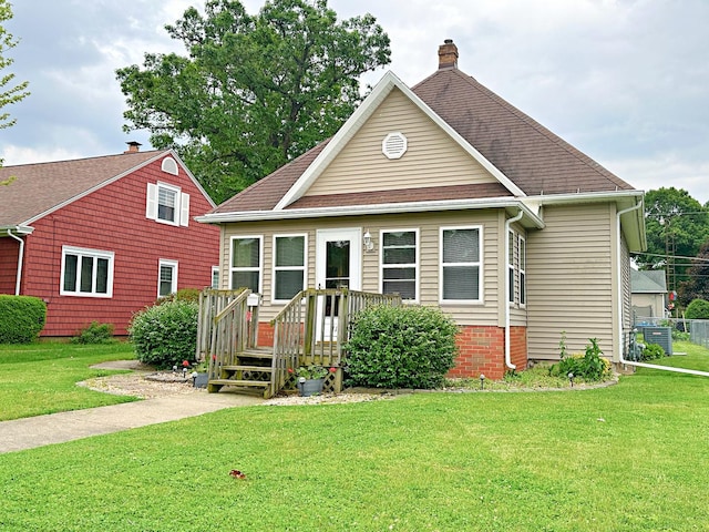 117 W 9th St, Streator, IL 61364 - view of front of home featuring a front lawn, a chimney, and central air condition unit