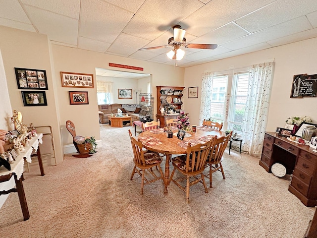 117 W 9th St, Streator, IL 61364 - dining room featuring a drop ceiling, a ceiling fan, carpet flooring, and plenty of natural light