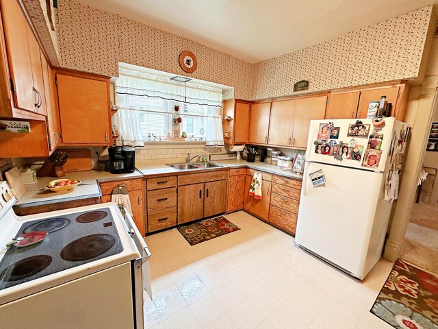 117 W 9th St, Streator, IL 61364 - kitchen featuring white appliances, a sink, light flooring, light countertops, and wallpapered walls
