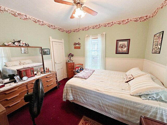 117 W 9th St, Streator, IL 61364 - bedroom featuring wainscoting, dark colored carpet, and a ceiling fan