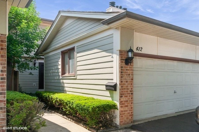 412 Bluebird Ln Unit 412, Deerfield, IL 60015 - view of property exterior with a chimney and brick siding