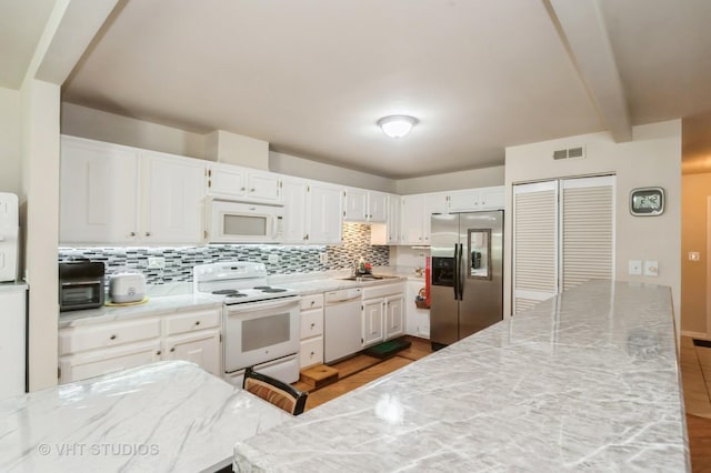 412 Bluebird Ln Unit 412, Deerfield, IL 60015 - kitchen featuring white appliances, decorative backsplash, white cabinets, dark wood-style flooring, and beam ceiling