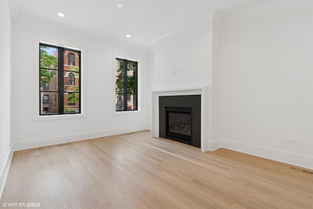 2118 N Sheffield Ave Unit 1, Chicago, IL 60614 - unfurnished living room featuring healthy amount of natural light, light wood-type flooring, a glass covered fireplace, recessed lighting, and ornamental molding