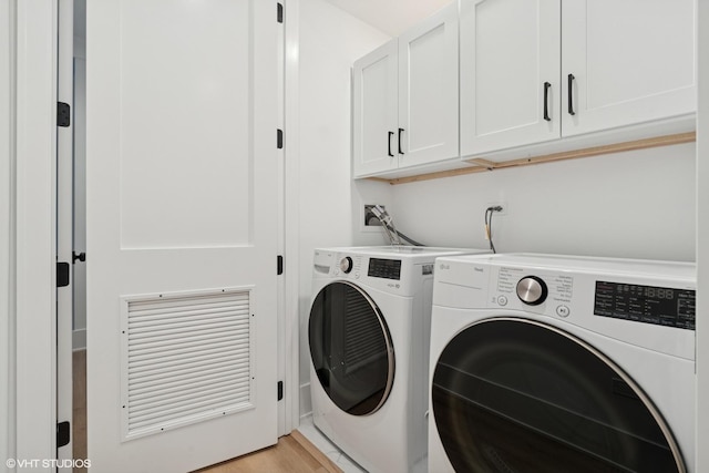 2118 N Sheffield Ave Unit 1, Chicago, IL 60614 - laundry room featuring cabinet space, washing machine and dryer, and light wood-style floors