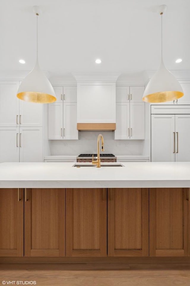 2118 N Sheffield Ave Unit 1, Chicago, IL 60614 - kitchen featuring light countertops, white cabinets, wall chimney range hood, recessed lighting, and pendant lighting