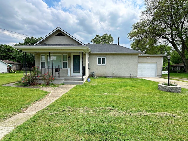 1003 Bazore St, Streator, IL 61364 - bungalow-style home with a porch, an attached garage, concrete driveway, stucco siding, and a front yard