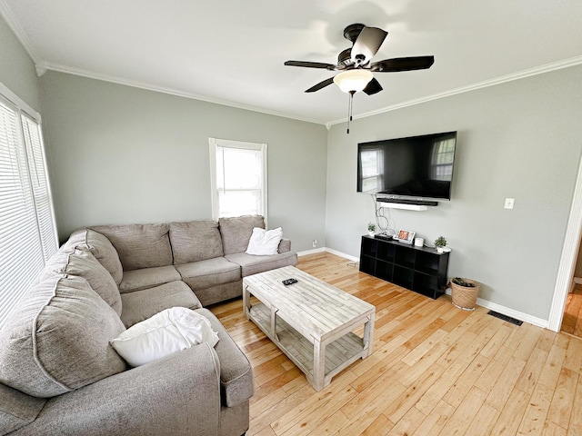 1003 Bazore St, Streator, IL 61364 - living area featuring crown molding, plenty of natural light, light wood-style floors, and baseboards