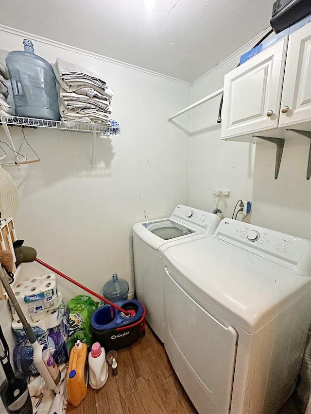 1003 Bazore St, Streator, IL 61364 - laundry area featuring cabinet space, wood finished floors, and independent washer and dryer