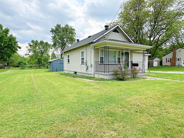 1003 Bazore St, Streator, IL 61364 - bungalow with covered porch, a front lawn, and stucco siding