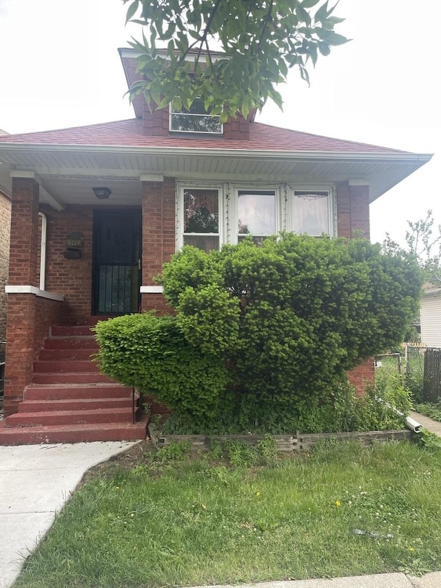 4119 N Moody Ave, Chicago, IL 60634 - view of front of home featuring brick siding, a porch, and a shingled roof
