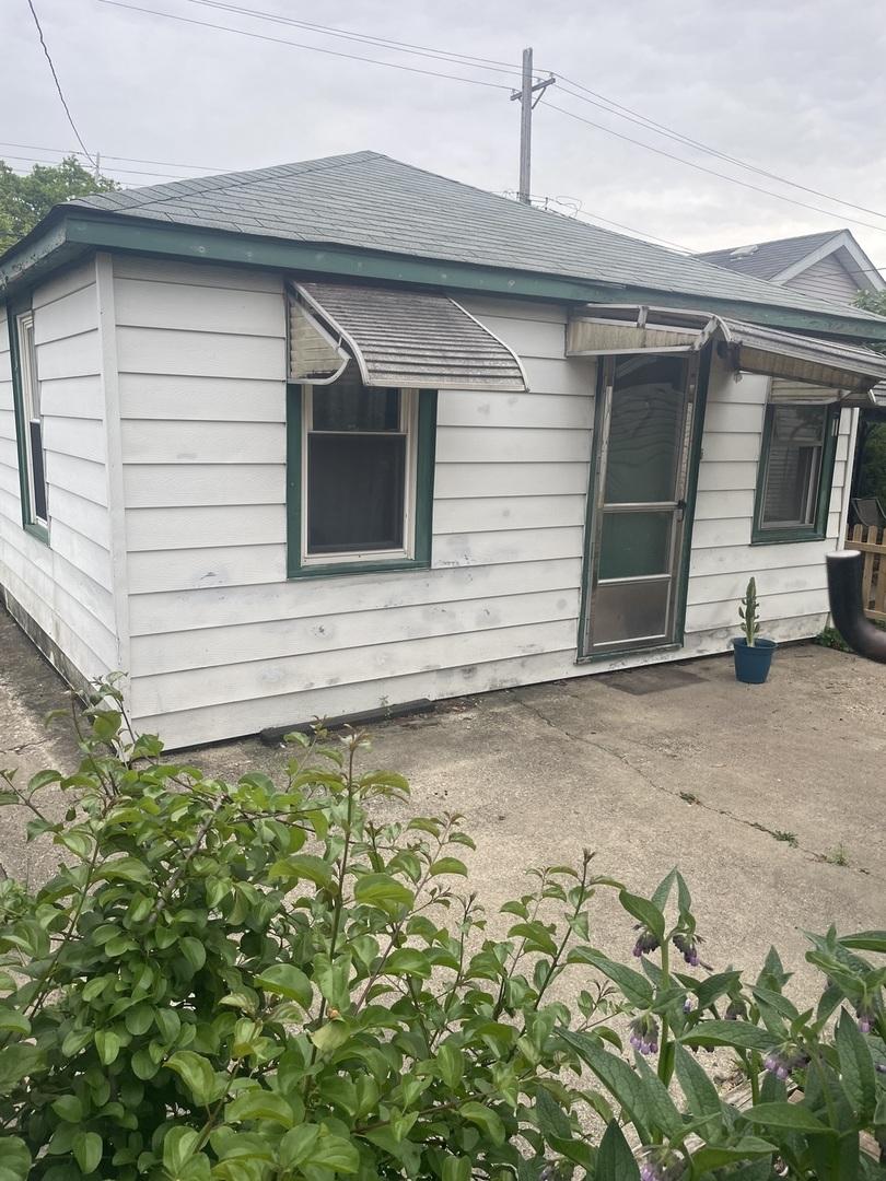 4119 N Moody Ave, Chicago, IL 60634 - rear view of property featuring roof with shingles and a patio area