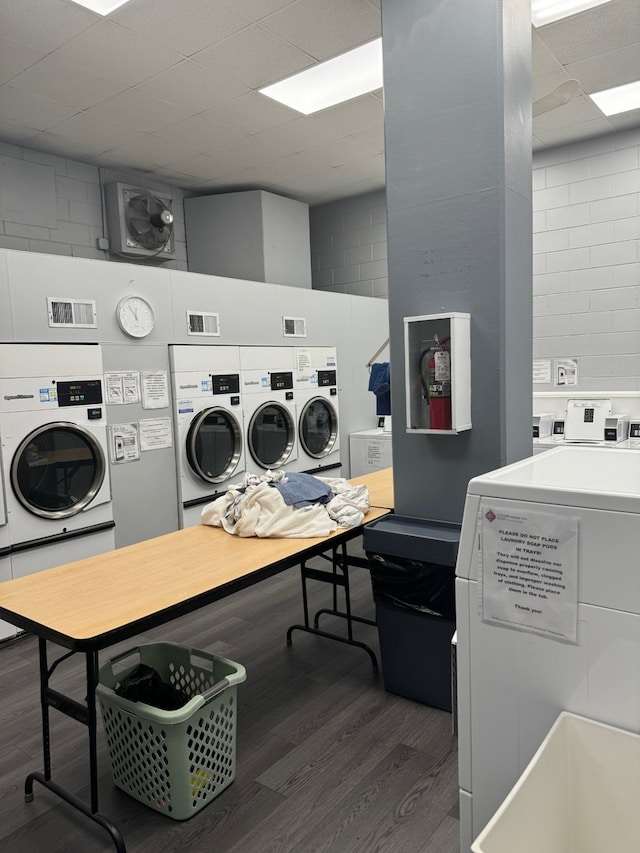 20 N Tower Rd Unit 6J, Oak Brook, IL 60523 - shared laundry featuring washer and clothes dryer, wood finished floors, concrete block wall, and a desk