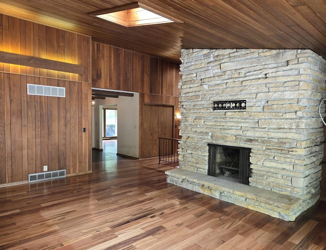 1720 Stratford Ln, Rockford, IL 61107 - unfurnished living room with wood walls, a fireplace, wood ceiling, and wood finished floors