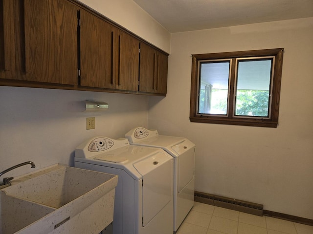 1720 Stratford Ln, Rockford, IL 61107 - laundry room featuring washer and clothes dryer, cabinet space, a baseboard heating unit, baseboards, and light tile patterned floors
