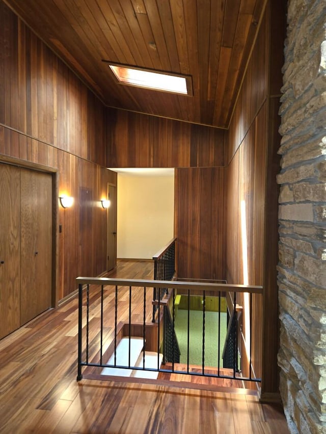 1720 Stratford Ln, Rockford, IL 61107 - stairway with wooden ceiling, wood-type flooring, wood walls, and a skylight