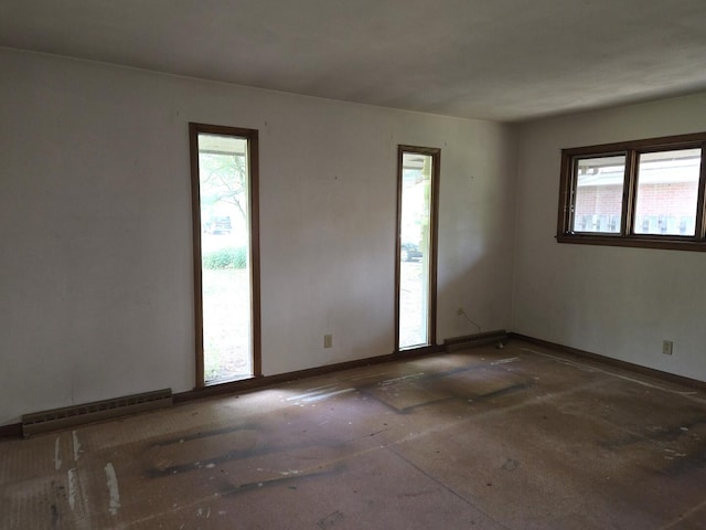 1720 Stratford Ln, Rockford, IL 61107 - spare room featuring baseboard heating, plenty of natural light, and baseboards