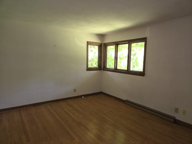 1720 Stratford Ln, Rockford, IL 61107 - unfurnished room featuring baseboard heating, wood finished floors, and baseboards
