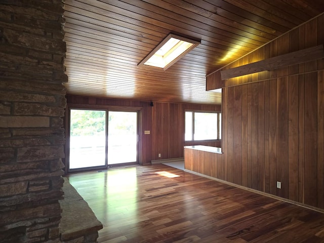 1720 Stratford Ln, Rockford, IL 61107 - unfurnished living room with a skylight, wood finished floors, wooden ceiling, wood walls, and baseboards