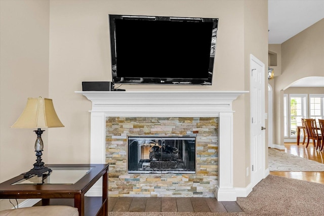 402 Cypress Ct, Saint Joseph, IL 61873 - detailed view of arched walkways, a glass covered fireplace, wood finished floors, and baseboards