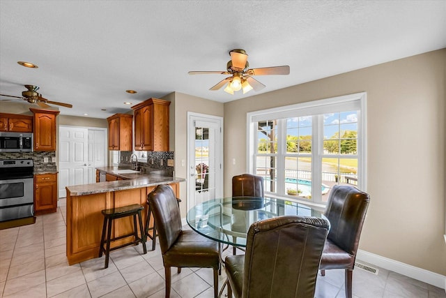 402 Cypress Ct, Saint Joseph, IL 61873 - dining room featuring ceiling fan, baseboards, light tile patterned floors, and recessed lighting