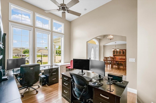 402 Cypress Ct, Saint Joseph, IL 61873 - home office with a chandelier, arched walkways, plenty of natural light, light wood finished floors, and a high ceiling