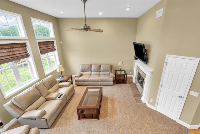 402 Cypress Ct, Saint Joseph, IL 61873 - living room with baseboards, recessed lighting, a high ceiling, a stone fireplace, and a ceiling fan