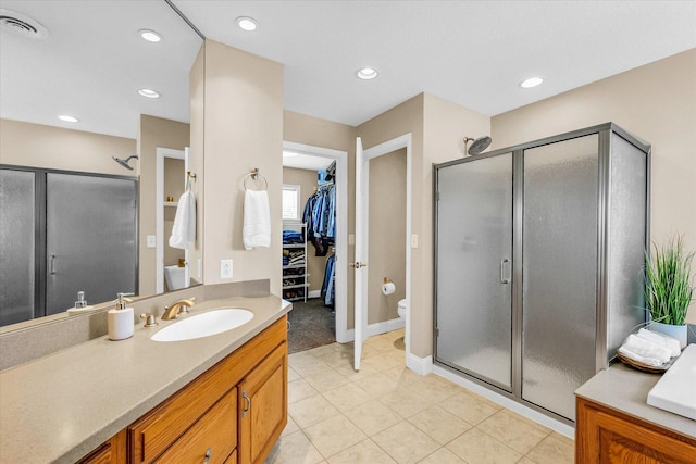 402 Cypress Ct, Saint Joseph, IL 61873 - bathroom featuring vanity, toilet, a stall shower, a walk in closet, and recessed lighting