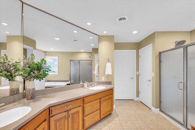 402 Cypress Ct, Saint Joseph, IL 61873 - bathroom featuring double vanity, a stall shower, a bath, recessed lighting, and tile patterned floors