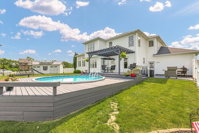 402 Cypress Ct, Saint Joseph, IL 61873 - outdoor pool with a pergola, a lawn, a deck, and a playground