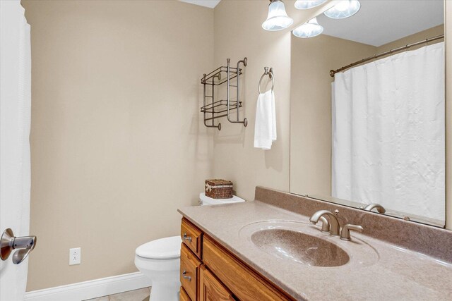 402 Cypress Ct, Saint Joseph, IL 61873 - full bath with toilet, vanity, tile patterned floors, and baseboards