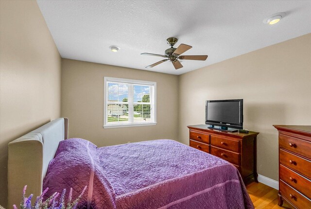 402 Cypress Ct, Saint Joseph, IL 61873 - bedroom featuring wood finished floors, baseboards, and ceiling fan