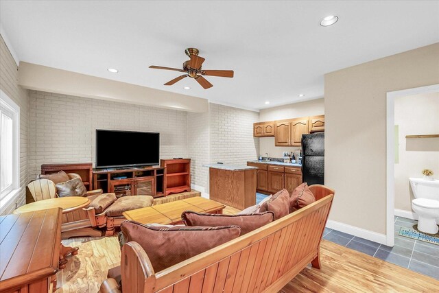 402 Cypress Ct, Saint Joseph, IL 61873 - living room featuring ceiling fan, brick wall, baseboards, tile patterned floors, and recessed lighting