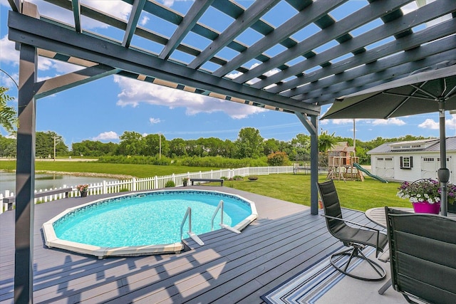 402 Cypress Ct, Saint Joseph, IL 61873 - view of swimming pool with a deck with water view, a pergola, a playground, and view of scattered trees