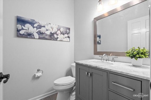 13214 Sunderlin Rd, Plainfield, IL 60585 - bathroom featuring vanity, toilet, wood finished floors, and baseboards
