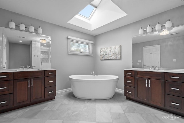 13214 Sunderlin Rd, Plainfield, IL 60585 - bathroom with a skylight, two vanities, a freestanding bath, and baseboards