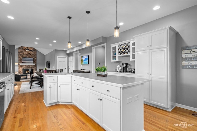 13214 Sunderlin Rd, Plainfield, IL 60585 - kitchen featuring open floor plan, light wood-style flooring, glass insert cabinets, white cabinetry, and light countertops
