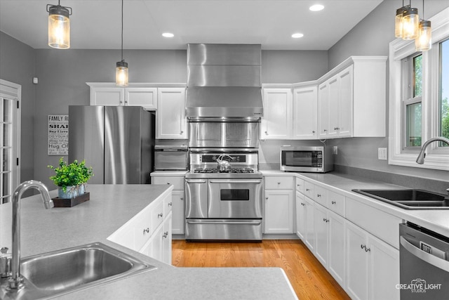 13214 Sunderlin Rd, Plainfield, IL 60585 - kitchen with appliances with stainless steel finishes, a sink, wall chimney range hood, white cabinetry, and recessed lighting