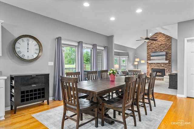 13214 Sunderlin Rd, Plainfield, IL 60585 - dining room with a ceiling fan, a fireplace, light wood finished floors, vaulted ceiling, and baseboards