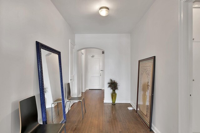 5555 N Sheridan Rd Unit 507, Chicago, IL 60640 - hallway with arched walkways, dark wood-style flooring, and baseboards