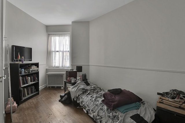 5555 N Sheridan Rd Unit 507, Chicago, IL 60640 - bedroom featuring radiator heating unit, wood-type flooring, and baseboards