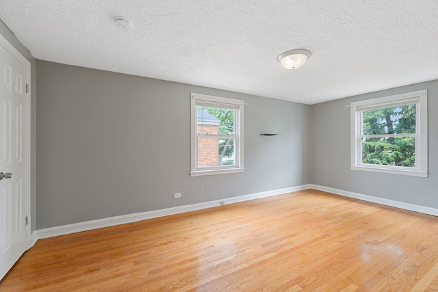 4308 Oak St, Bellwood, IL 60104 - empty room with light wood-style flooring, a textured ceiling, and a smoke detector