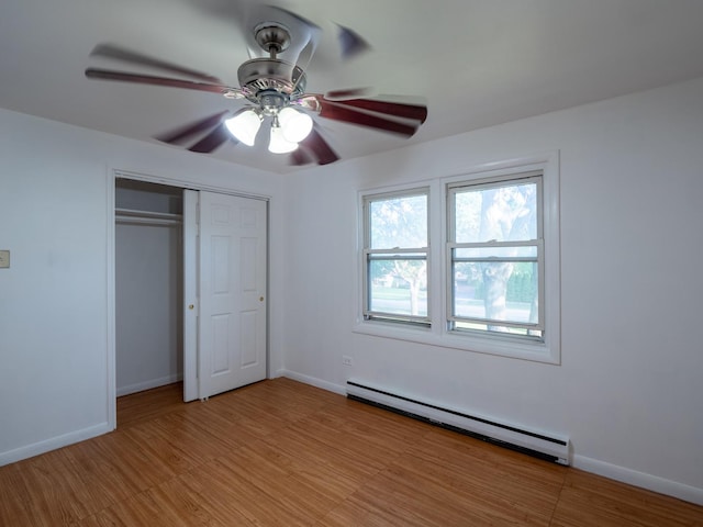 6862 W Lode Dr Unit 3A, Worth, IL 60482 - unfurnished bedroom featuring a baseboard radiator, a closet, baseboards, ceiling fan, and light wood-style flooring
