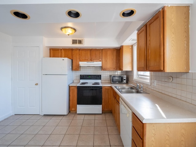 6862 W Lode Dr Unit 3A, Worth, IL 60482 - kitchen featuring white appliances, under cabinet range hood, a sink, brown cabinets, and tasteful backsplash