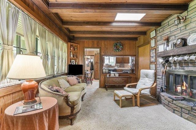 1314 S Chester Ave, Park Ridge, IL 60068 - carpeted living area featuring wood walls, a stone fireplace, and wood ceiling with exposed beams
