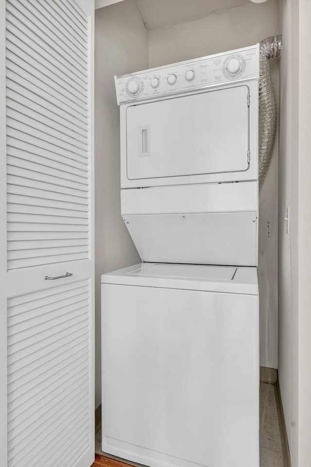 125 S Jefferson St Unit 710, Chicago, IL 60661 - laundry room featuring stacked washing machine and dryer and baseboards