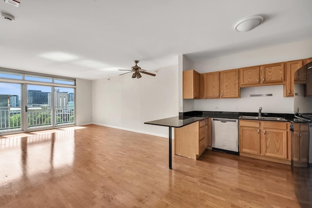 125 S Jefferson St Unit 710, Chicago, IL 60661 - kitchen featuring dishwasher, light wood-style flooring, a sink, and dark countertops