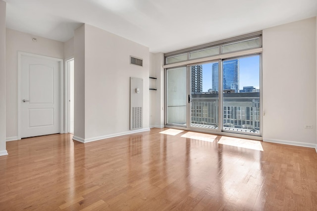 125 S Jefferson St Unit 710, Chicago, IL 60661 - unfurnished room with wood finished floors, baseboards, and a view of city