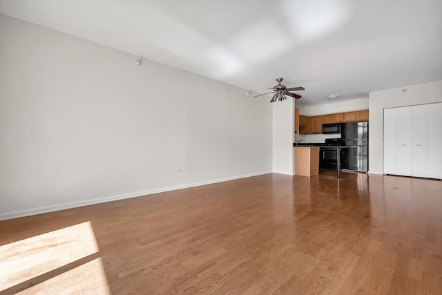 125 S Jefferson St Unit 710, Chicago, IL 60661 - unfurnished living room with ceiling fan, baseboards, and wood finished floors