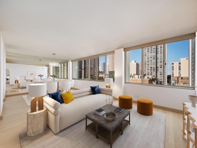 1 E Schiller St Unit 8B, Chicago, IL 60610 - living room with light wood-style flooring, a city view, baseboards, and a chandelier
